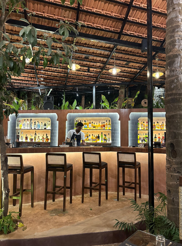 Whiskey Rasam restaurant interior in rust and brass